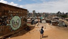 A boy walks in front of a graffiti promoting the fight against the coronavirus disease (COVID-19) in the Mathare slums of Nairobi, Kenya, May 22, 2020. REUTERS/Baz Ratner TPX IMAGES OF THE DAY