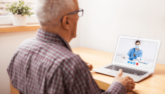 Young e-doctor consulting elderly man,online video help line virtual medical appointment,GP prescribing medication to senior patient,telemedicine diagnosis,tele visit remote health concept